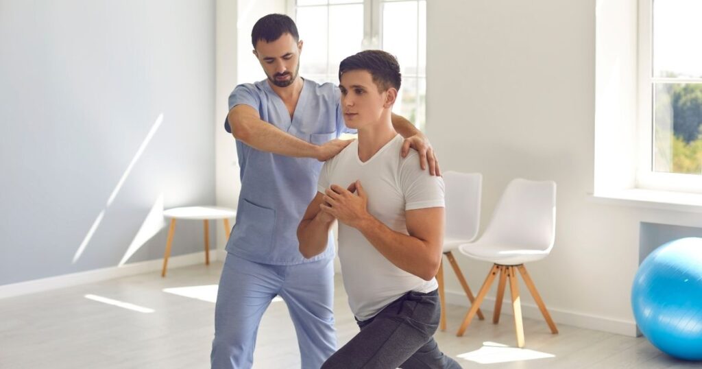 Physical therapist working with male patient.