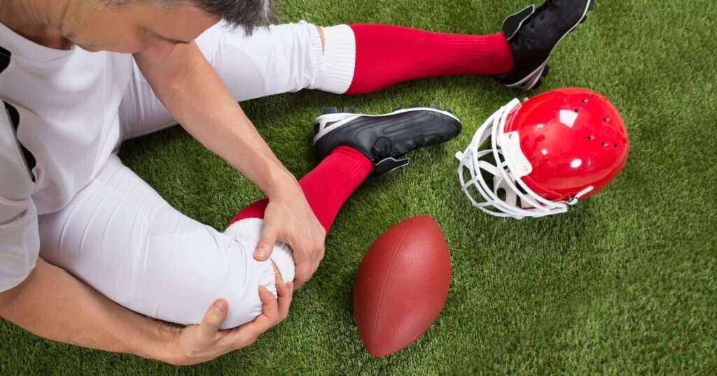 A football player with an injured knee.